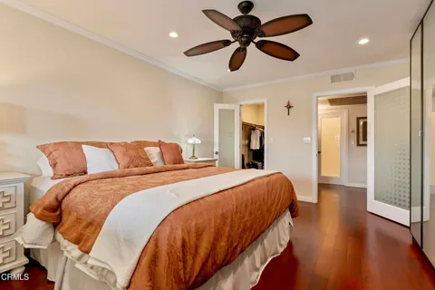 a bedroom with bed and a chandelier