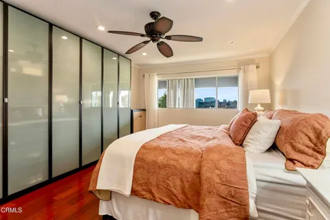 a bedroom with a large bed and a chandelier