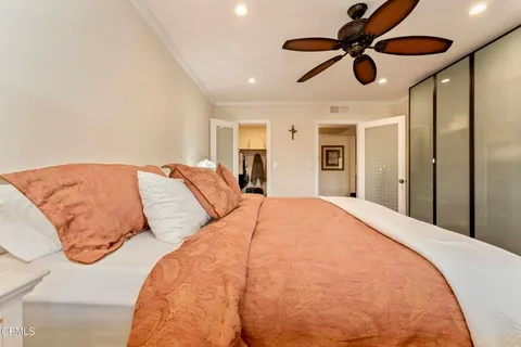 a bed room with a large bed and a chandelier