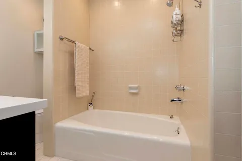 a white bath tub sitting next to a white sink