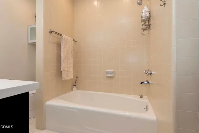 a white bath tub sitting next to a white sink