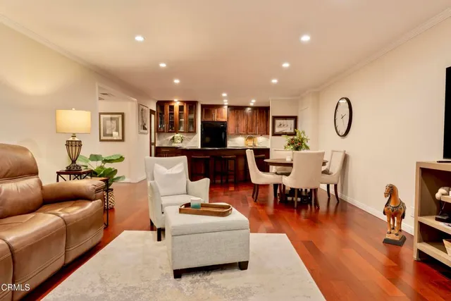 a living room with furniture kitchen view and a dining table