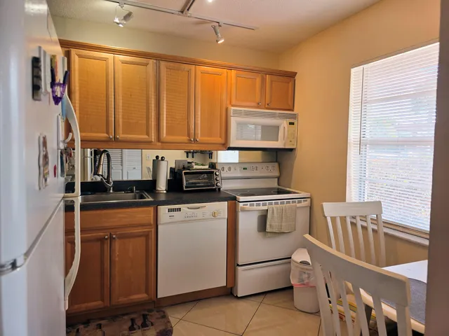 a kitchen with stainless steel appliances granite countertop a stove a sink dishwasher and cabinets