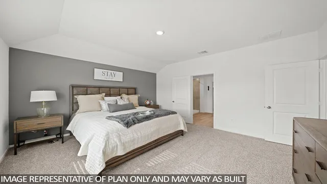 a bedroom with a bed and a night stand