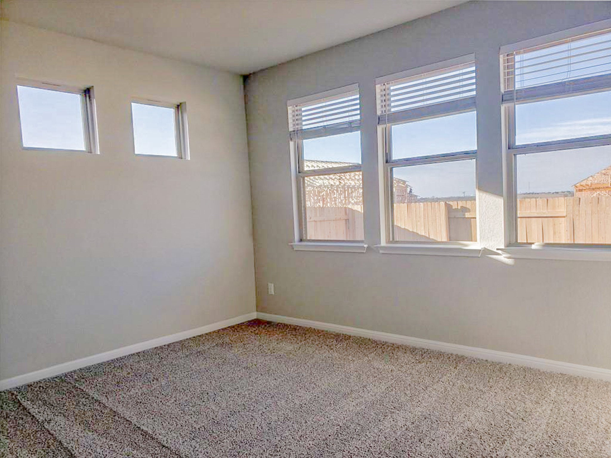221 El Dorado Road Jarrell, TX 76537 - Photo 10 of 17 Empty room with light carpet and healthy amount of natural light