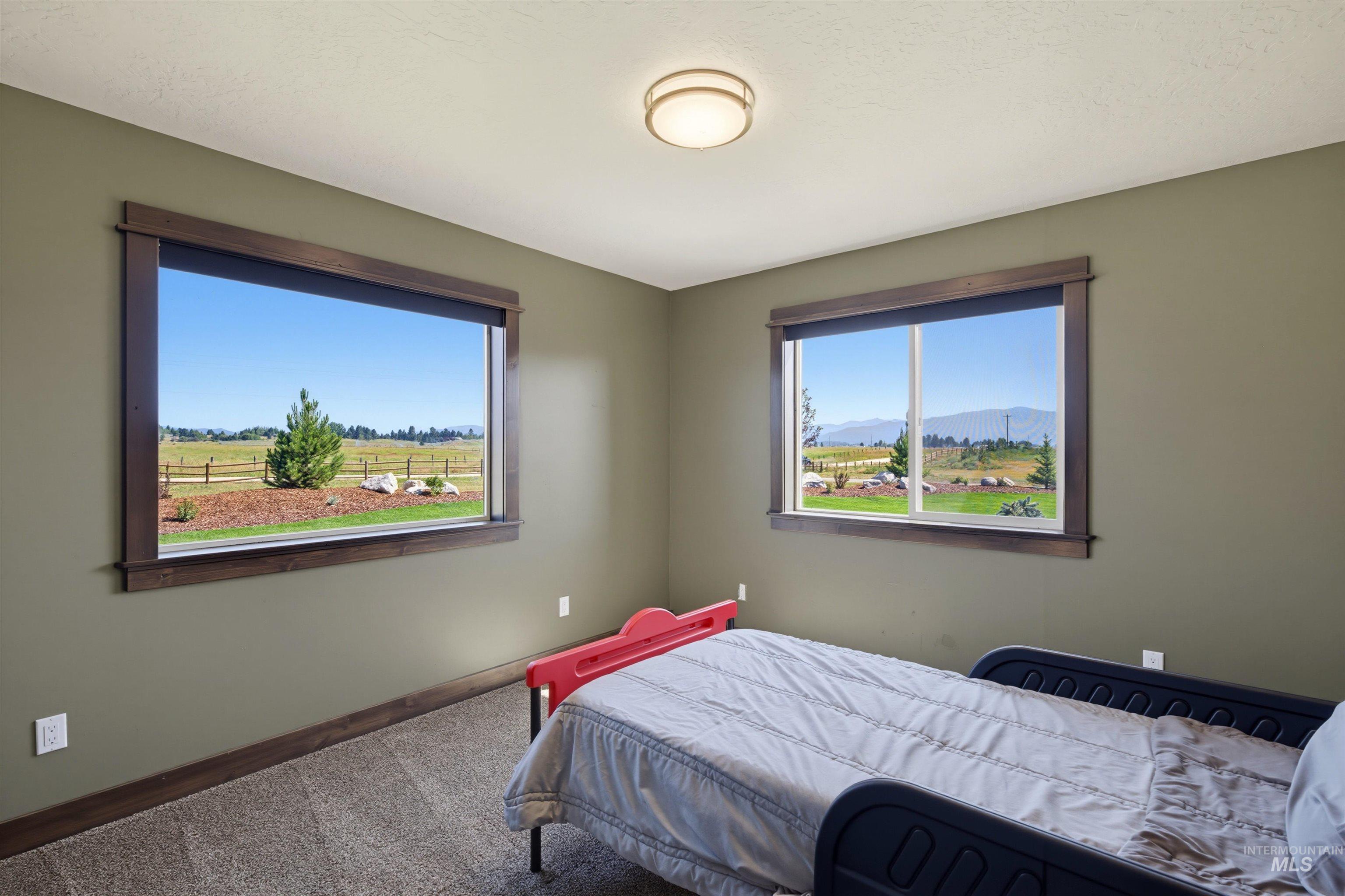 13945 Galloping Road McCall, ID 83638 - Photo 24 of 50 Interior space featuring two windows with dark wood-finish trim, offering expansive outdoor scenery