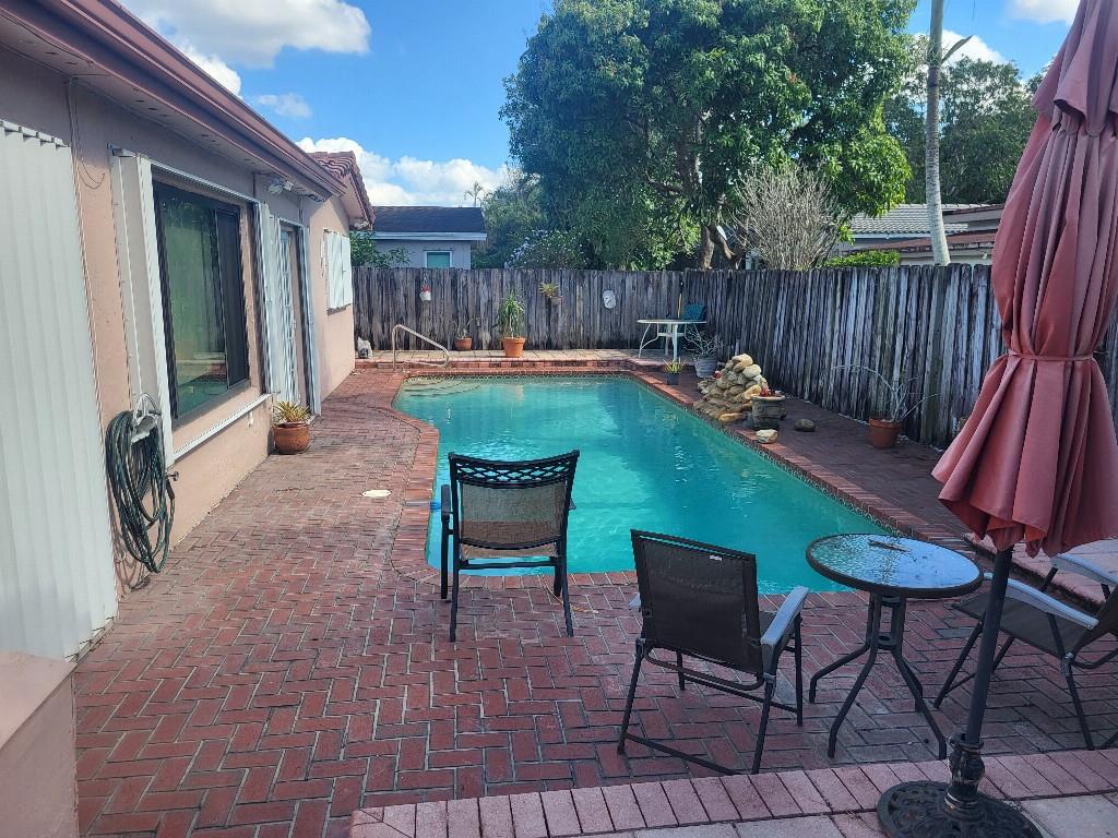10478 Northwest 4th Street Plantation, FL 33324 - Photo 15 of 15 a backyard of a house with table and chairs