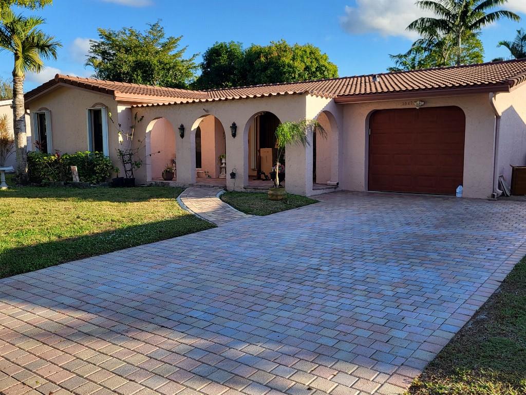 10478 Northwest 4th Street Plantation, FL 33324 - Photo 2 of 15 a view of a house with a patio and a yard