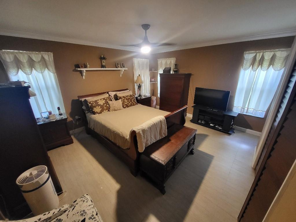 10478 Northwest 4th Street Plantation, FL 33324 - Photo 5 of 15 a bedroom with bed and window