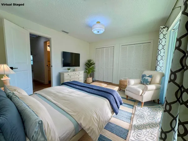 a bedroom with a bed and a television