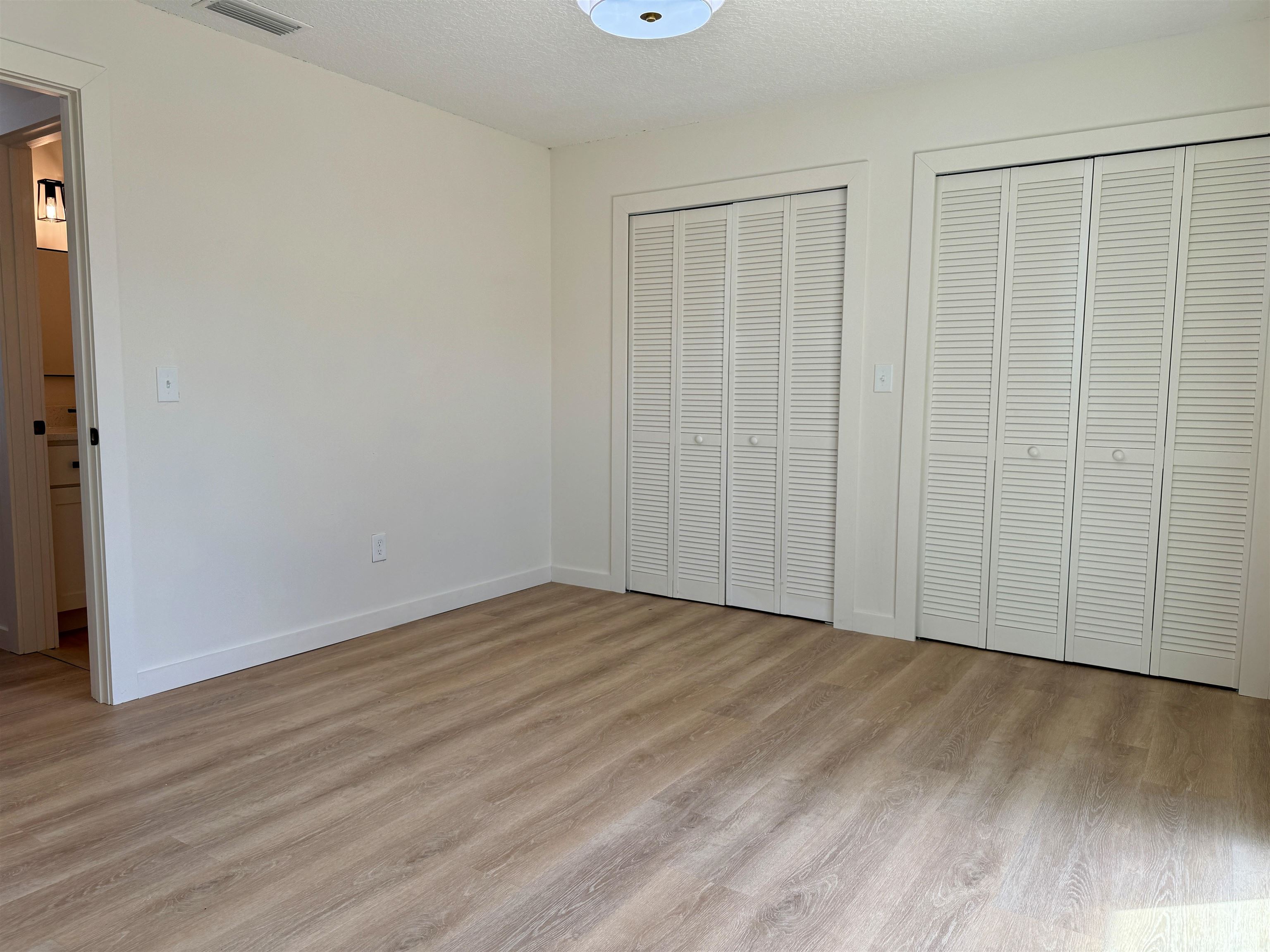 205 6th Street St. Augustine, FL 32080 - Photo 9 of 18 a view of an empty room with wooden floor