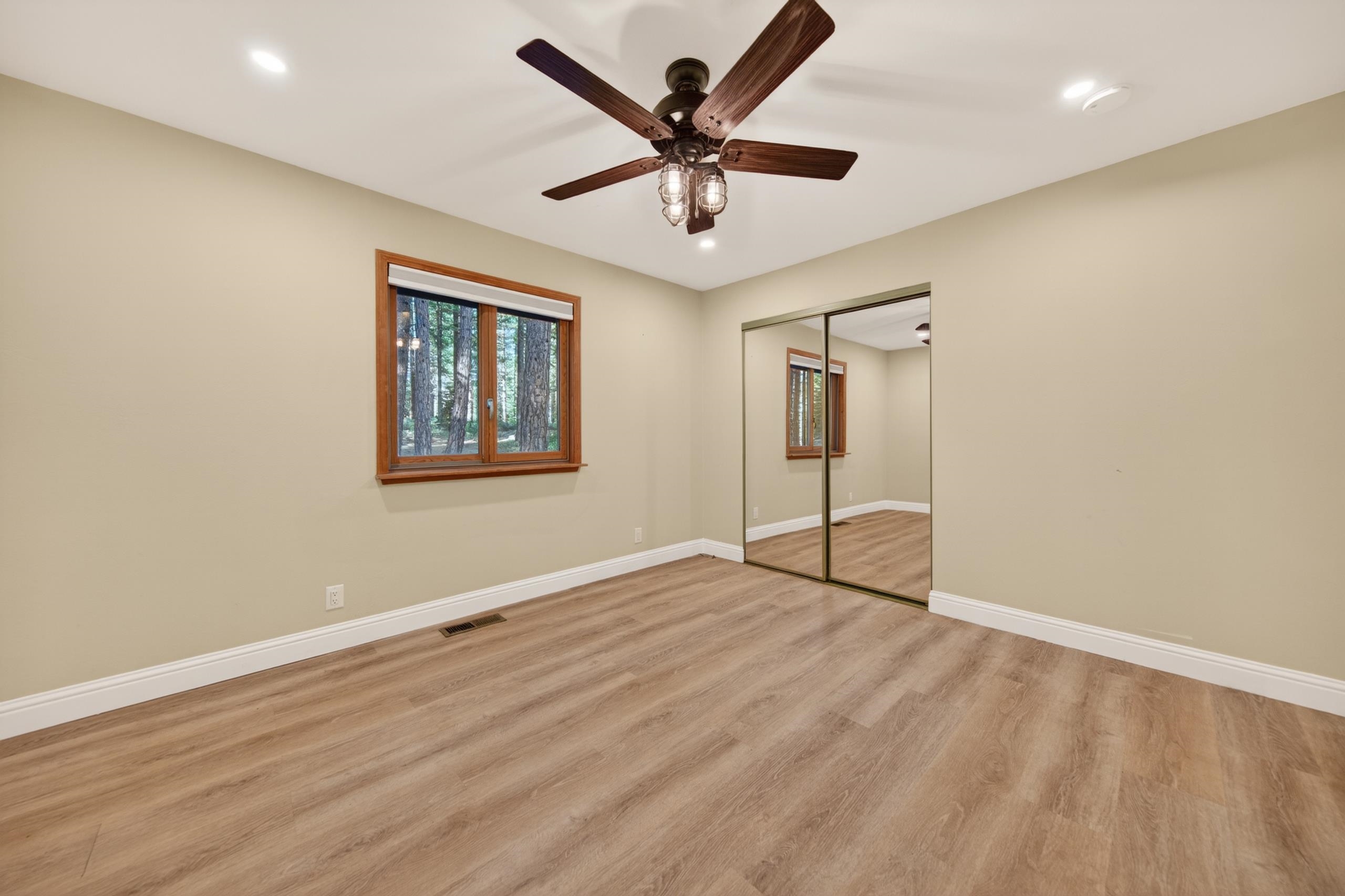 463-000 Moonlight Ranch Rd Westwood Road Susanville, CA 96130 - Photo 26 of 46 an empty room with wooden floor and ceiling fan