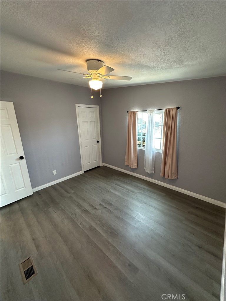 3825 Crestmore Road, Unit 414 Riverside, CA 92509 - Photo 16 of 31 an empty room with wooden floor and windows