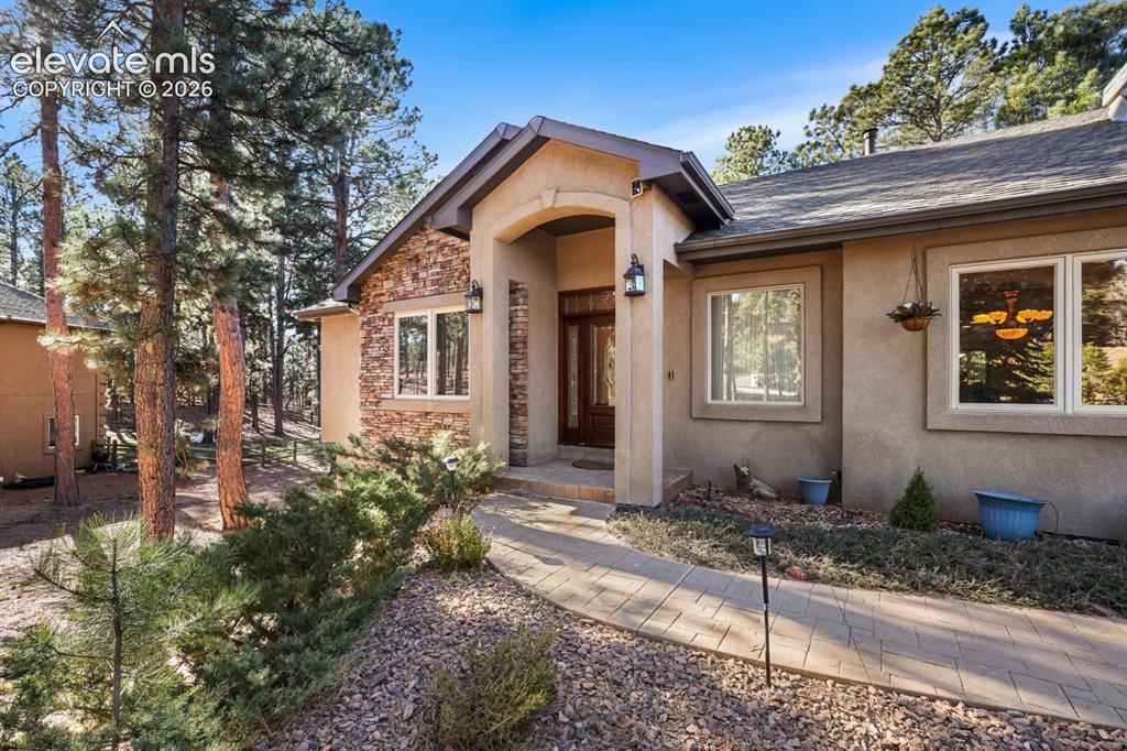 17990 Sawmill Road Colorado Springs, CO 80908 - Photo 20 of 40 Concrete-paver walkway to the covered front porch