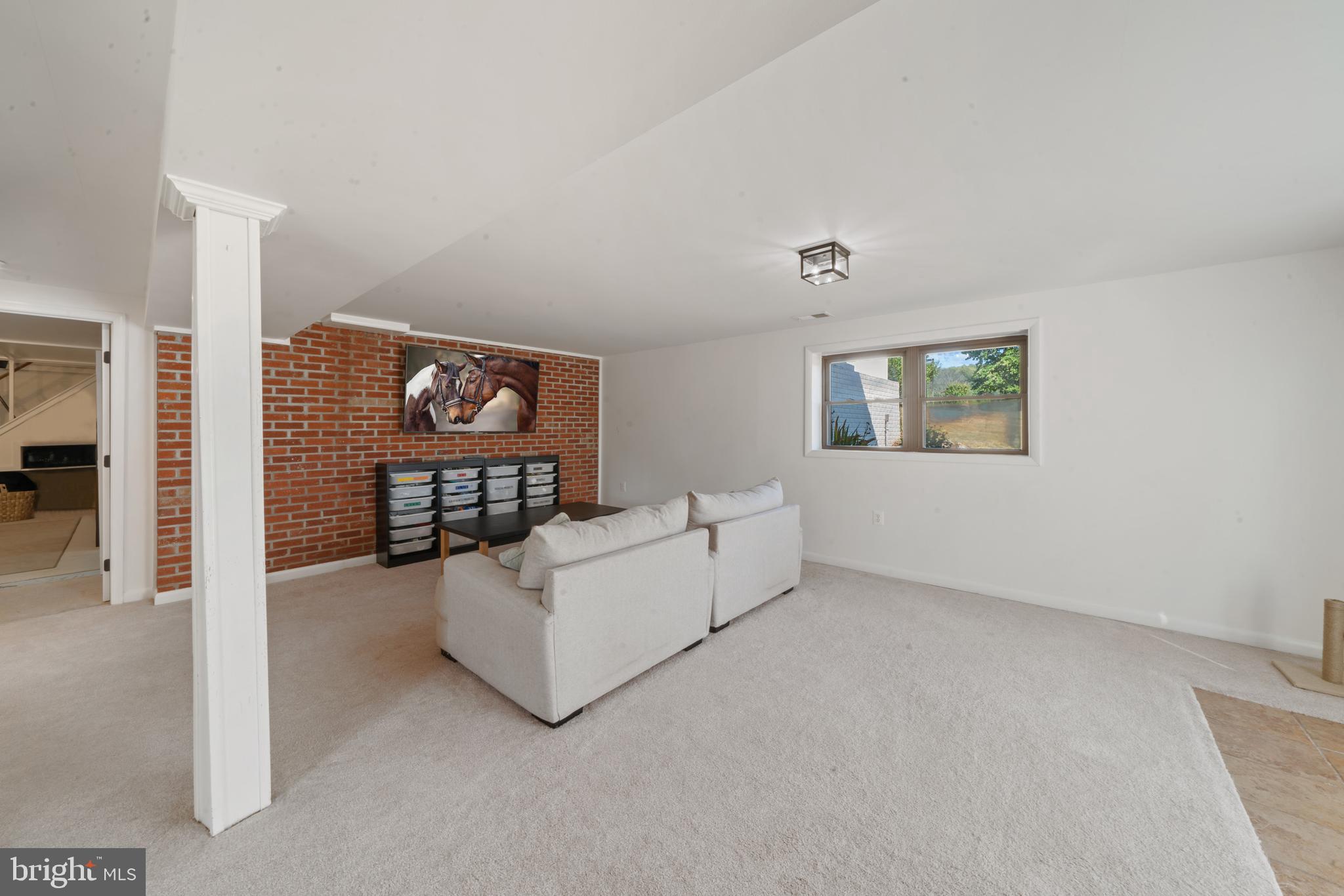 4040 Mills Road Sharpsburg, MD 21782 - Photo 45 of 127 Lower level family room with brick wall accent