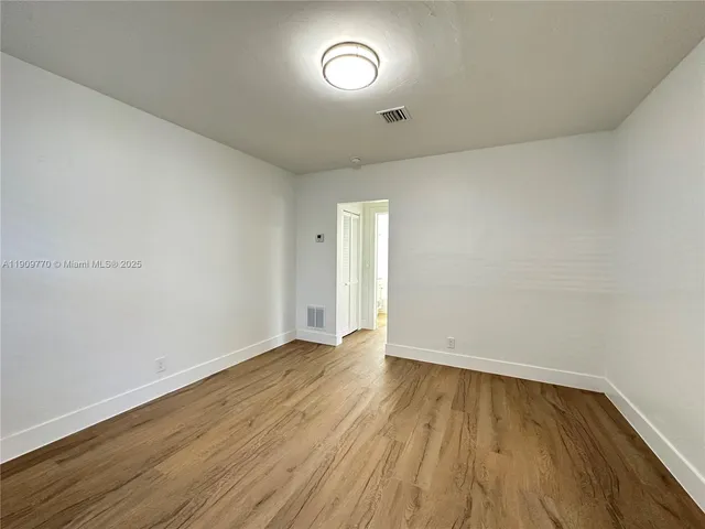 a view of room with wooden floor