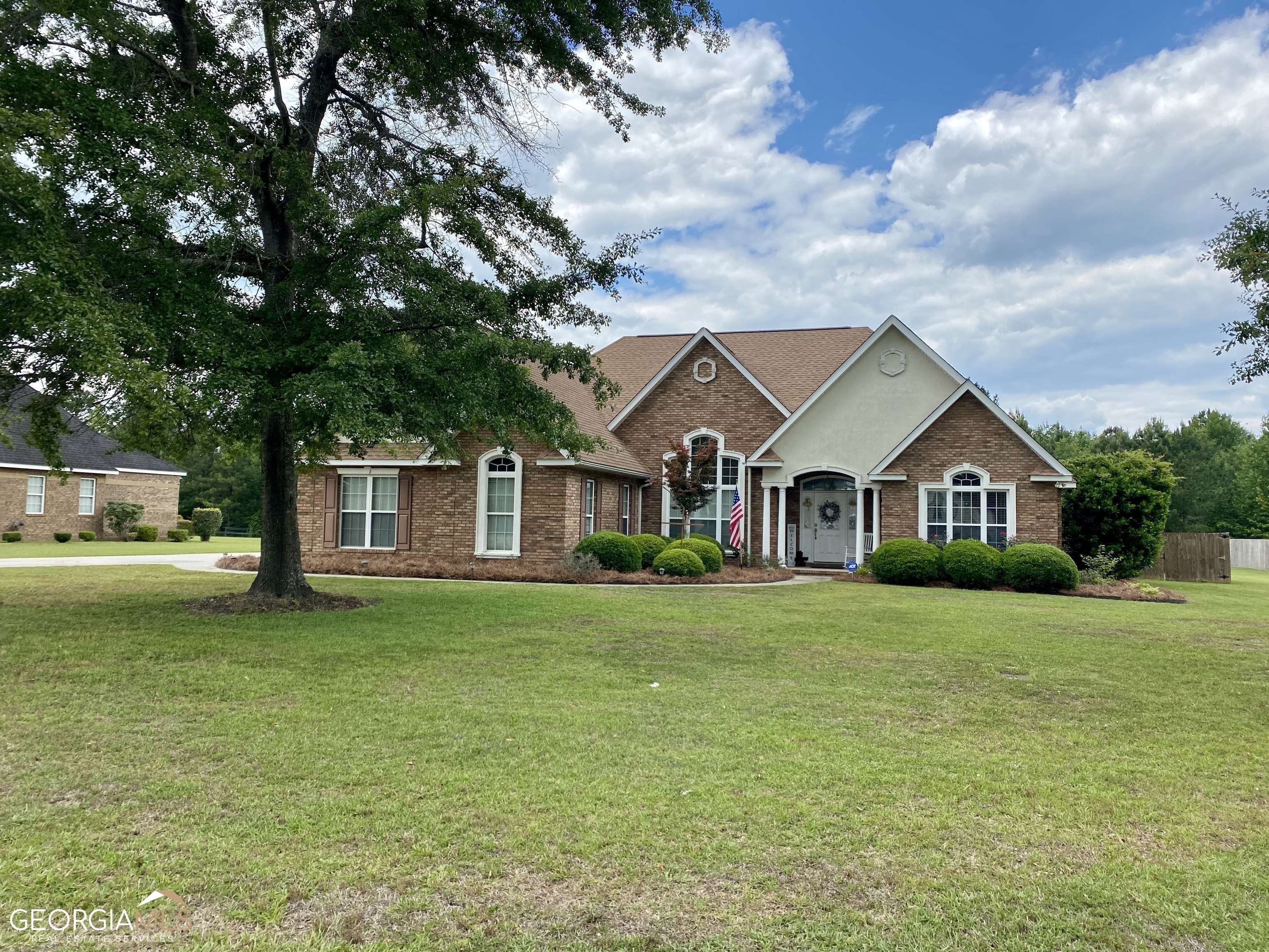 102 Hedge Way Dublin, GA 31021 - Photo 1 of 1 a front view of a house with a garden