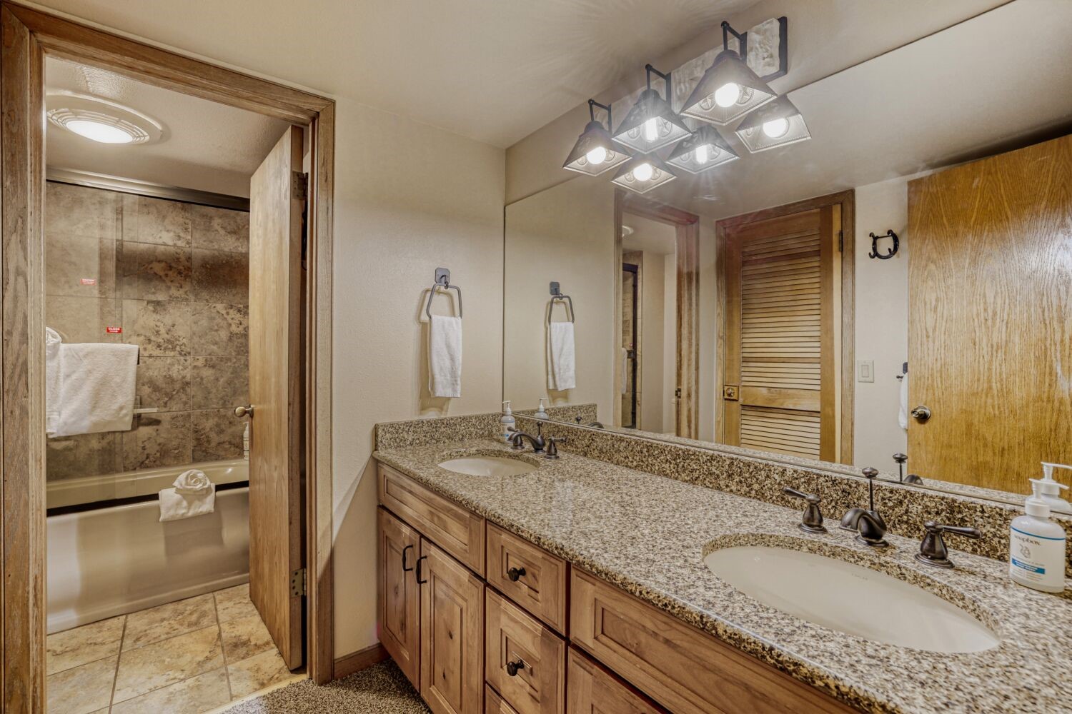 22804 Highway 6, Unit 108 Keystone, CO 80435 - Photo 13 of 28 Bathroom featuring double vanity and combined bath / shower with glass door