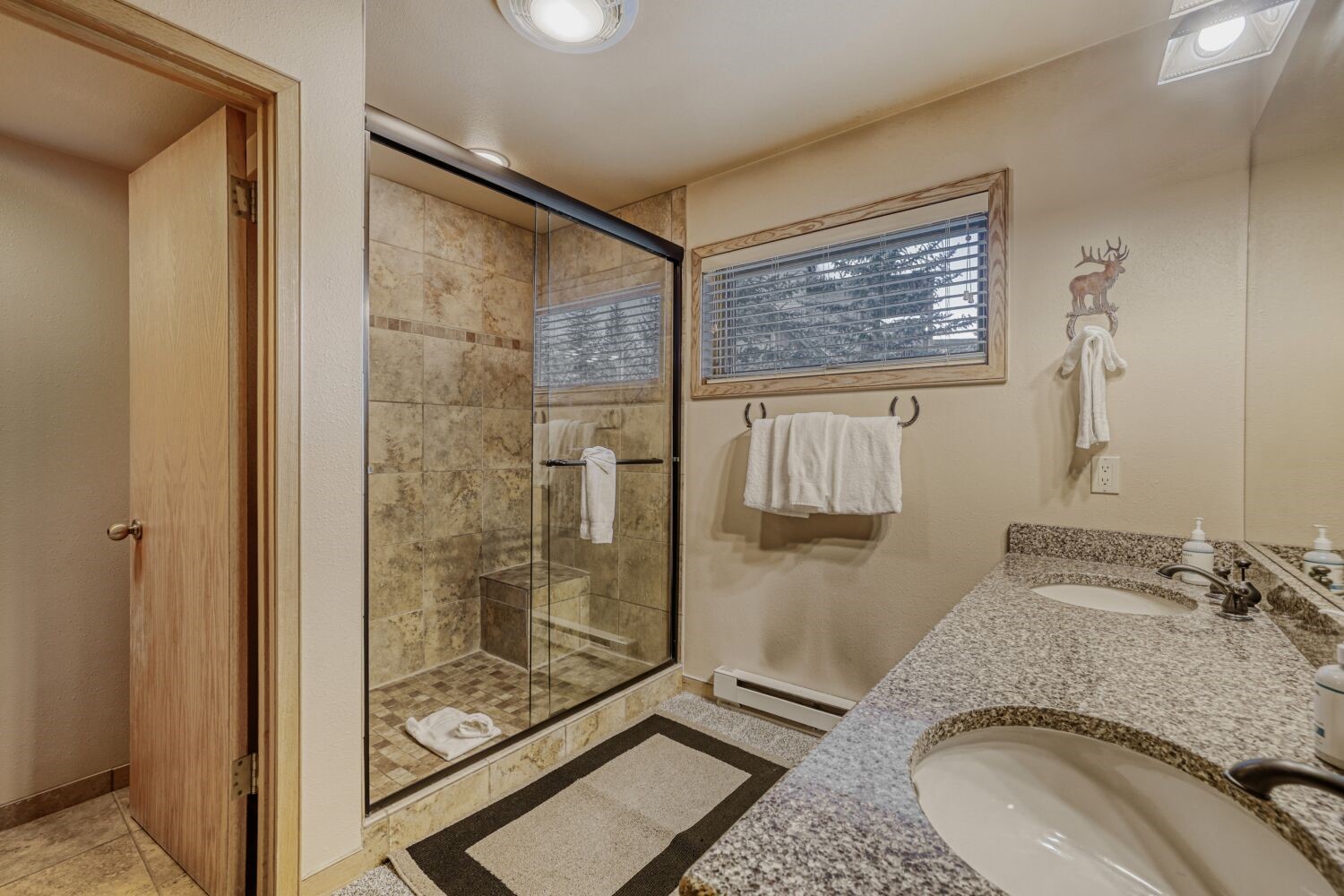 22804 Highway 6, Unit 108 Keystone, CO 80435 - Photo 26 of 28 Full bath featuring a shower stall, a baseboard heating unit, and double vanity