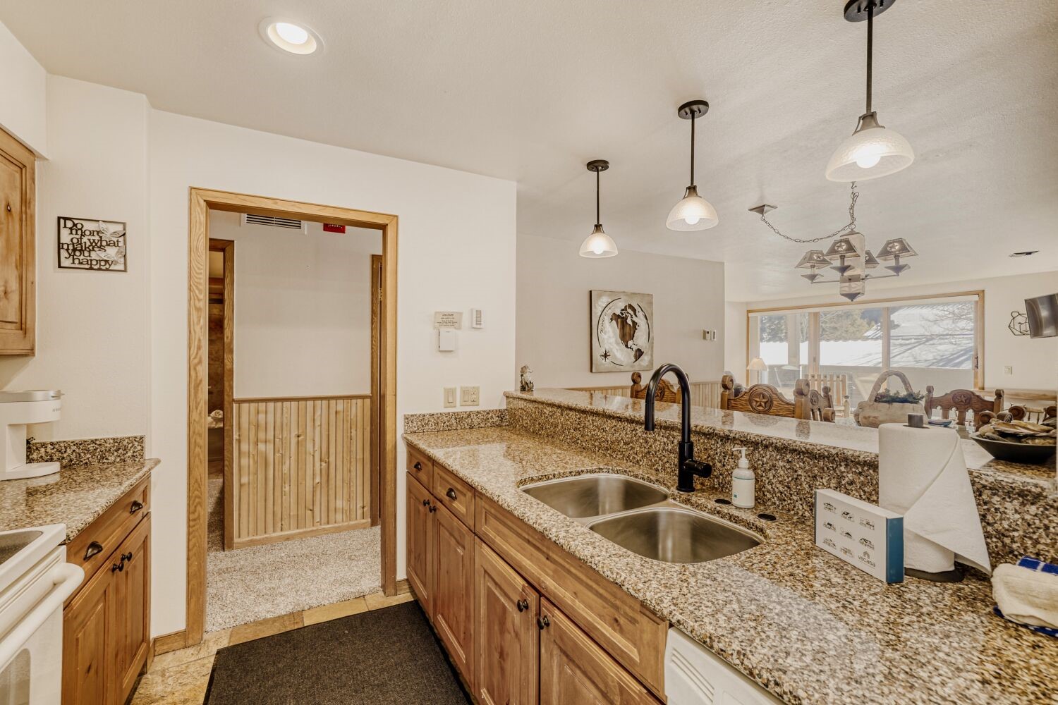 22804 Highway 6, Unit 108 Keystone, CO 80435 - Photo 8 of 28 Kitchen with light stone countertops, white range, open floor plan, and wood finish cabinets