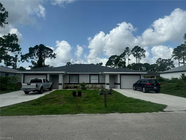 a view of a house with backyard sitting area and garden