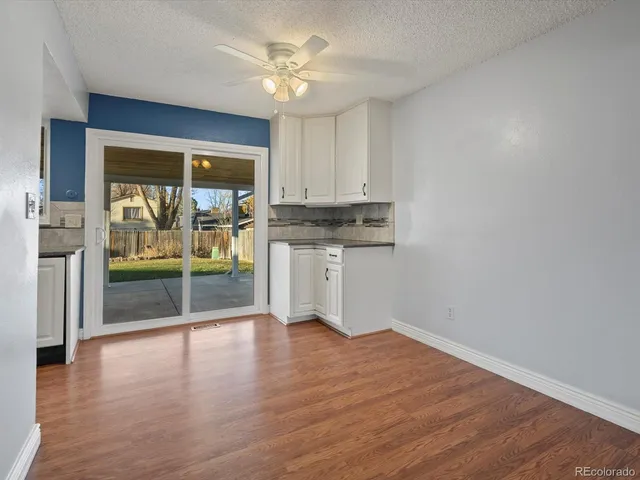 a view of wooden floor and a window in a room