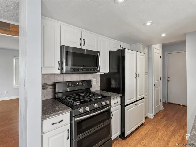 a kitchen with a stove and a refrigerator