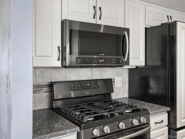 a kitchen with a stove and a microwave