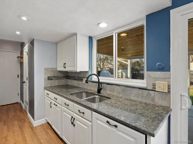 a kitchen with granite countertop a sink and a window