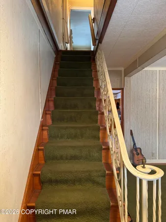 a bathroom with a granite countertop sink a toilet and mirror