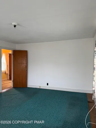 a view of an empty room and window
