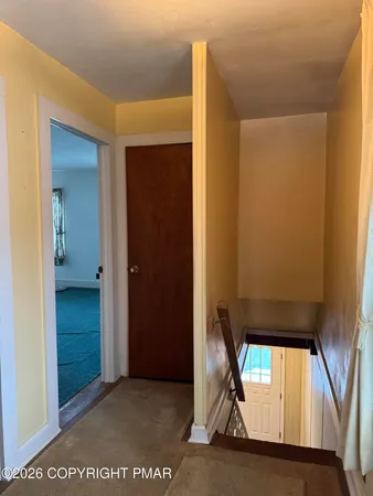 an empty room with a ceiling fan and a window