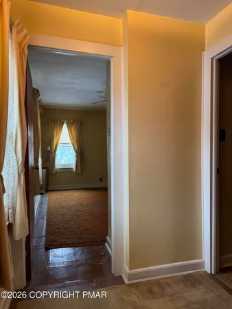 a view of entryway and hall with a chandelier