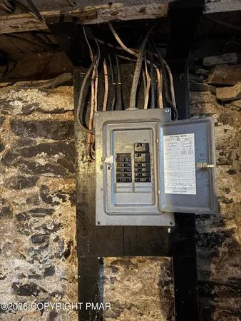 a room with water heater and wooden walls