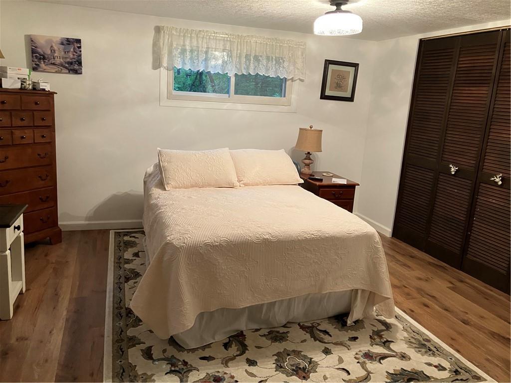 450 Old Plank Road Butler, PA 16002 - Photo 11 of 32 a bedroom with a bed and wooden floor