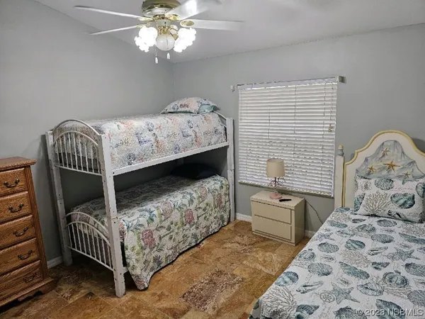 a bedroom with a bed and a chair