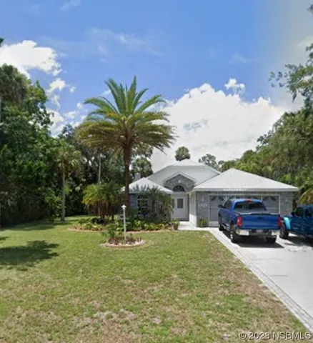 a yellow house with trees in front of it