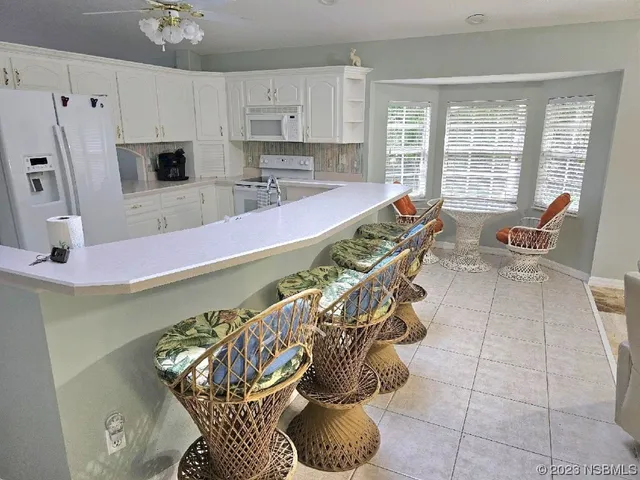 a dining room with furniture and a window