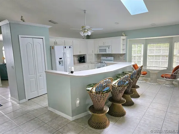 a dining room filled with furniture and chandelier