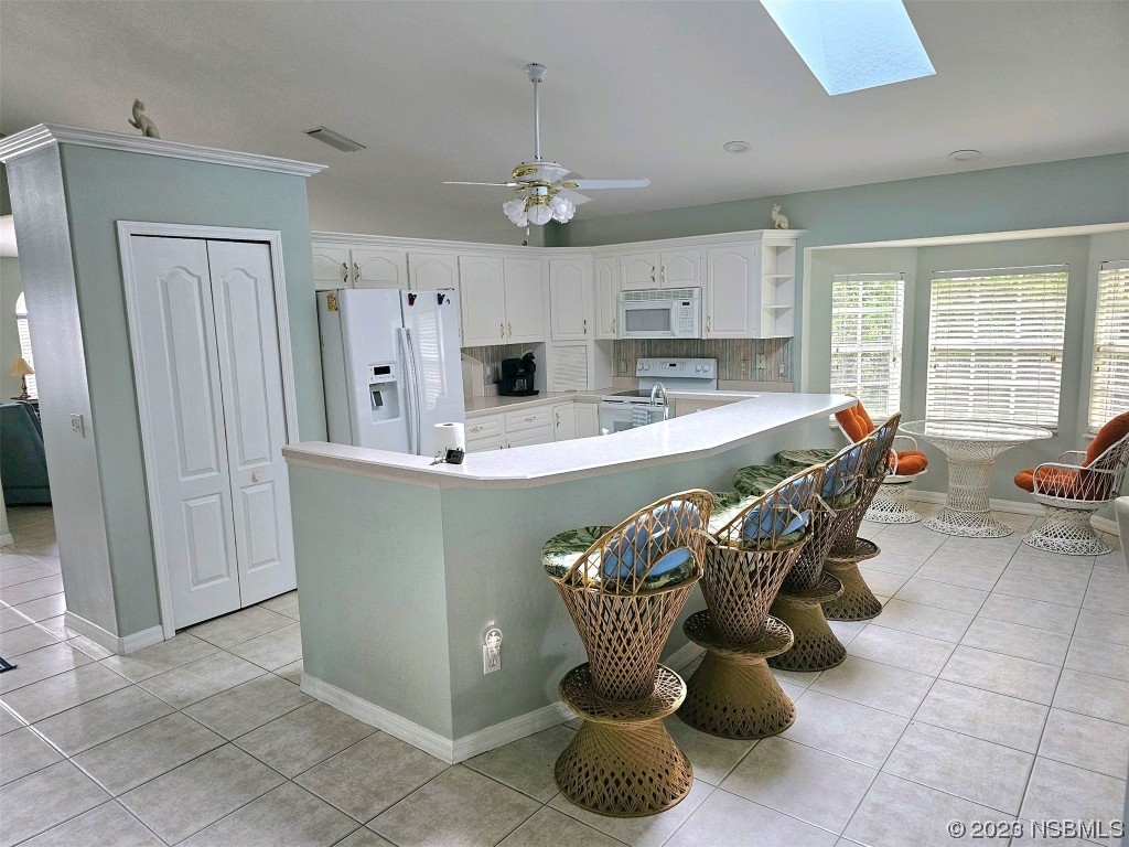 1308 South Riverside Drive Edgewater, FL 32132 - Photo 9 of 16 a dining room filled with furniture and chandelier