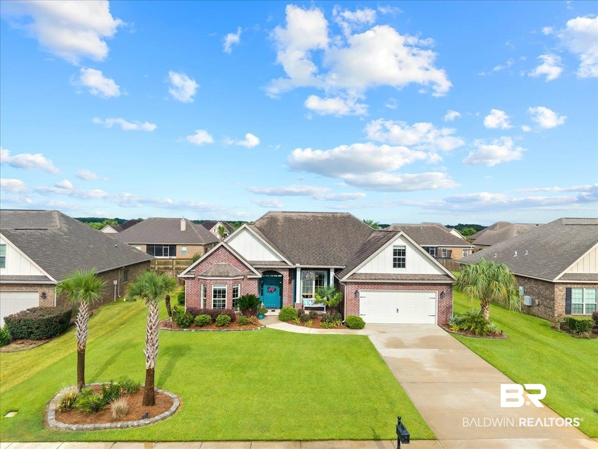 7056 Rocky Rd Loop Gulf Shores, AL 36542 - Photo 41 of 41 Craftsman house with concrete driveway, brick siding, a front lawn, board and batten siding, and a residential view