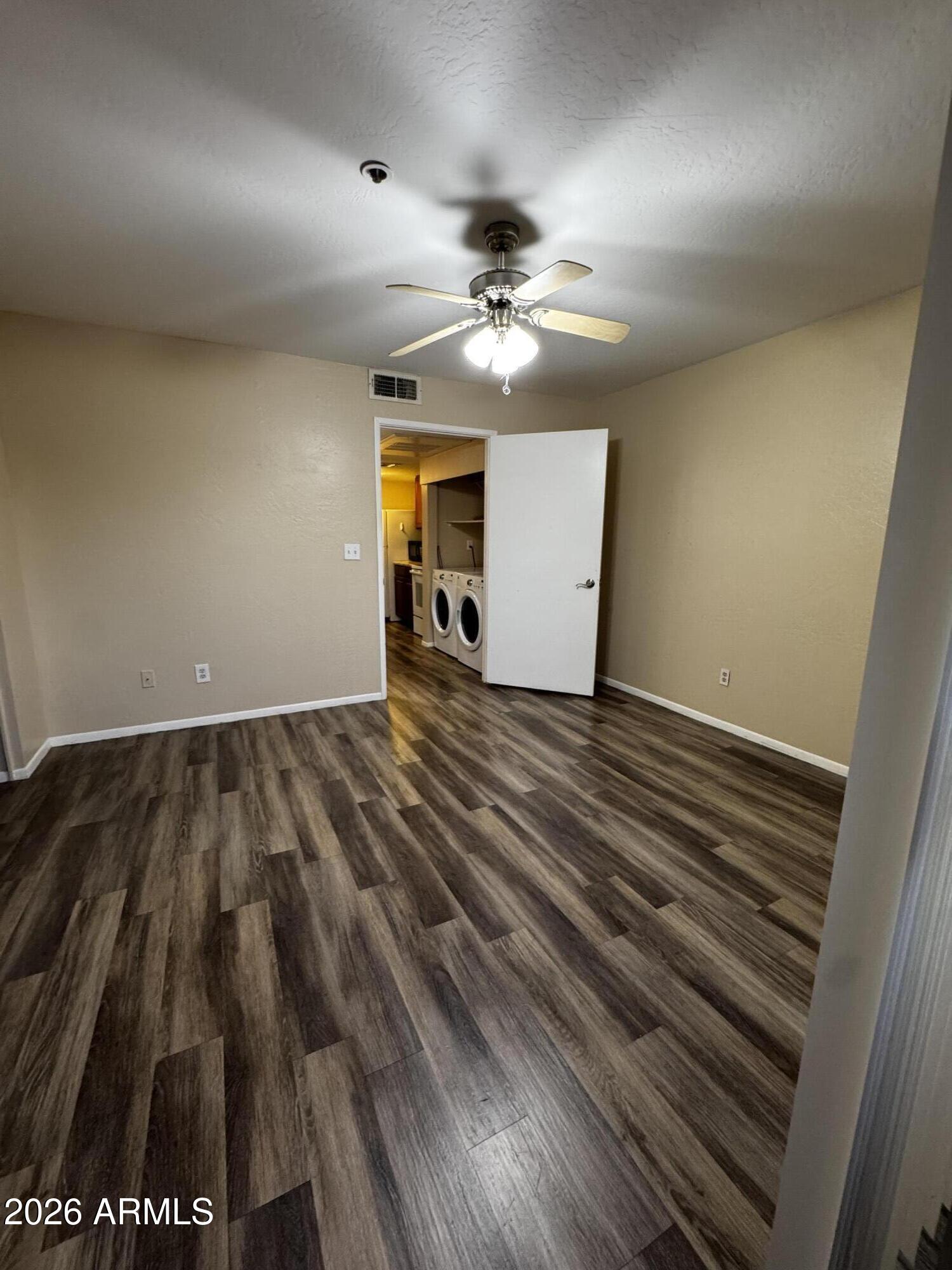 12123 West Bell Road, Unit 258 Surprise, AZ 85378 - Photo 14 of 30 wooden floor in an empty room with a window