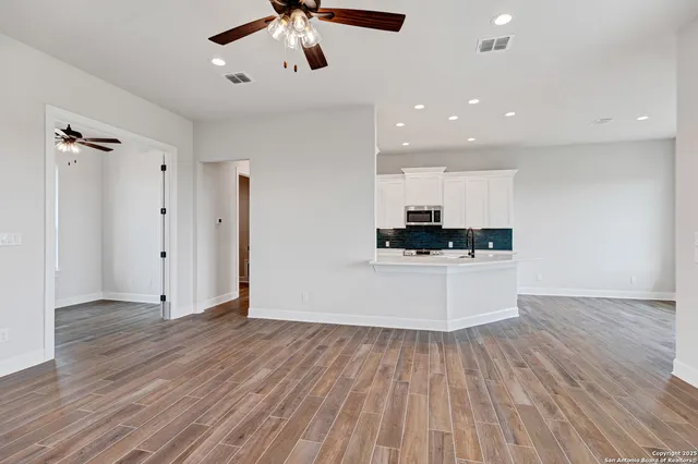 a view of kitchen with refrigerator microwave and stove