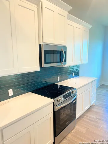 a kitchen with granite countertop a stove and a sink
