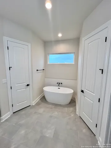 a bathroom with a bathtub sink and toilet