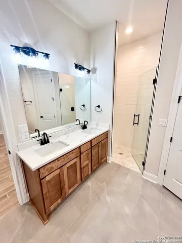 a bathroom with a sink double vanity and a mirror