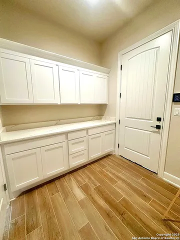 a view of a kitchen with wooden floor and cabinet