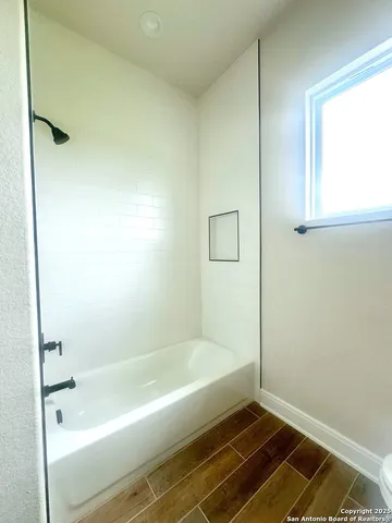 a bathroom with a bathtub and a shower