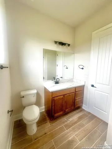 a spacious bathroom with a mirror and a toilet