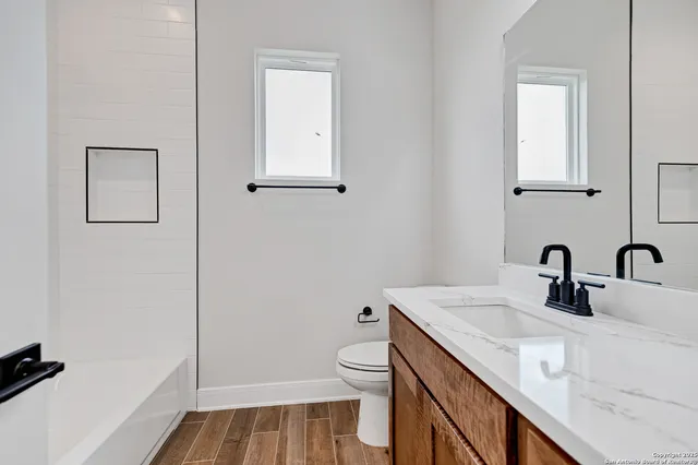 a bathroom with a sink toilet and vanity